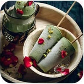 Two green icecreams on the plate