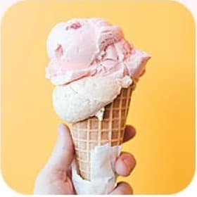 Hand holding icecream on the yellow background