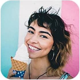 Young woman holding icecream near the face